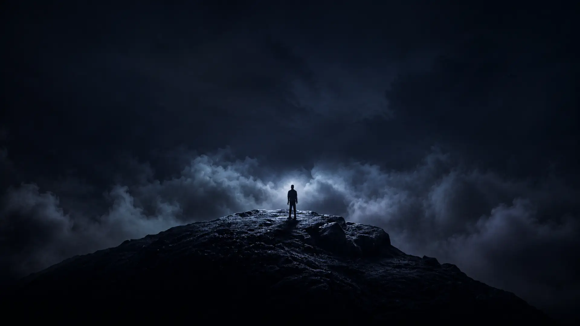 Night scene: a small human figure on a rocky peak in the fog, watching the N emerge from the chaos.
